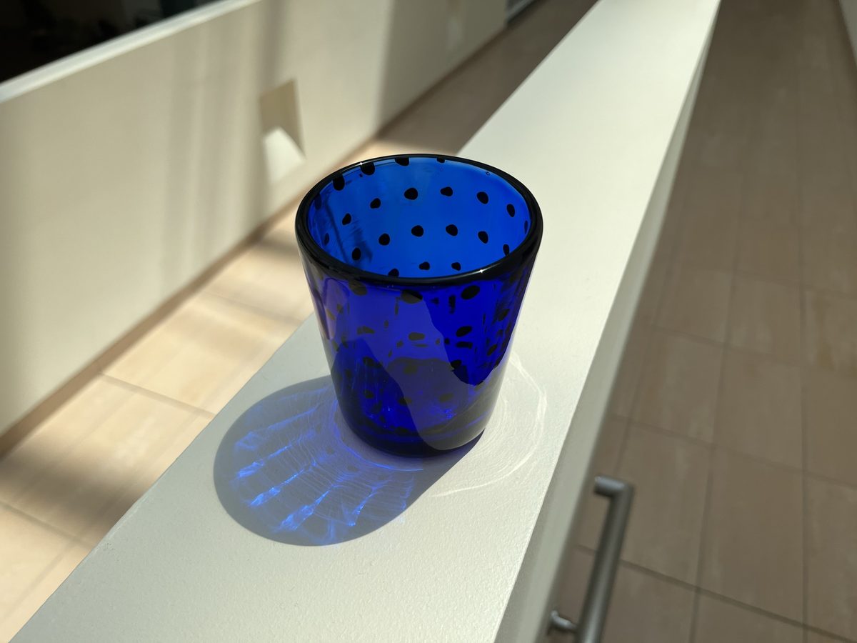 Cobalt blue glass cup with black dots
